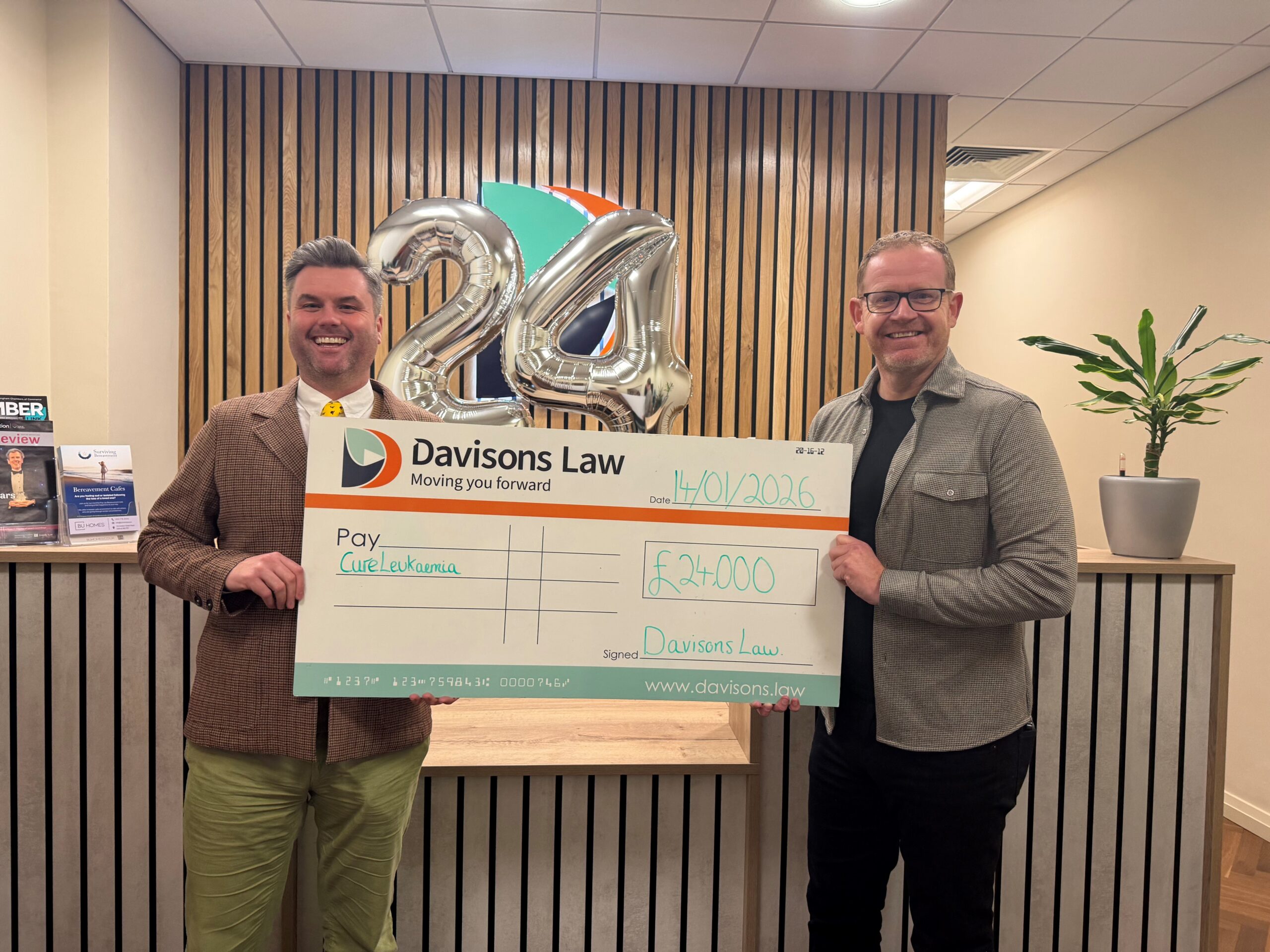 Darryl Wilkes from Davisons Law presenting the cheque for £24,000 to Cure Leukaemia's CEO James McLaughlin